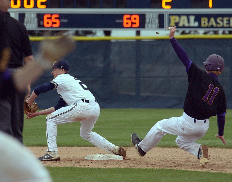 Helias second baseman Dawson Meyer forces an out as Hickman's Teague Robertson slides during Friday's game in the Capital City Invitational at the American Legion Post 5 Sports Complex.