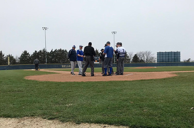 Coaches and officials prepare Saturday, April 6, 2019, at the American Legion Post 5 Sports Complex for the start of the seven-place game of the Capital City Invitational between Show-Me Conference foes Russellville and Fatima.