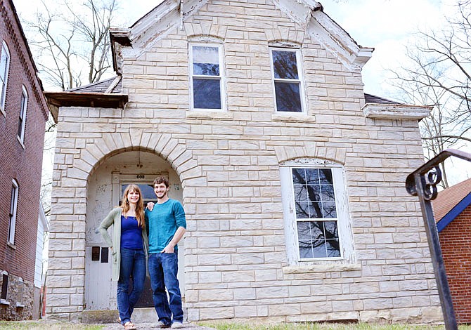 Dustin and Mandi Long stand outside their property Thursday at 608 E. State St. The home is the first property in the East Capitol Avenue Urban Renewal Zone to be redeveloped. 