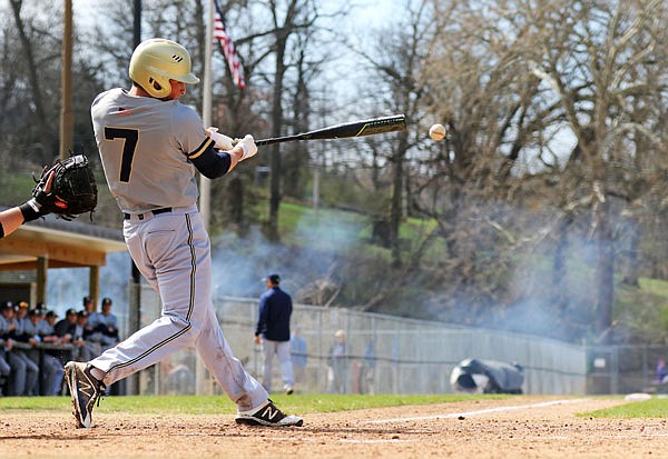 Jacob Weaver of Helias sends a single to left field during the fifth inning of Saturday's third-place game of the Capital City Invitational against Eureka at Vivion Field.