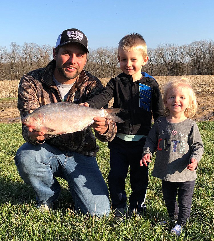 Brian Rehmeier, of Augusta, pictured with children Jack Rehmeier and Emma Rehmeier, broke a state record by snagging a 2-pound, 10-ounce gizzard shad on Bigelow Creek in St. Charles County.