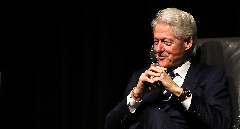 Former President Bill Clinton sits on stage Saturday, April 6, 2019, as the keynote speaker for the Hope/Hempstead County Chamber of Commerce annual meeting and banquet in Hope, Ark.