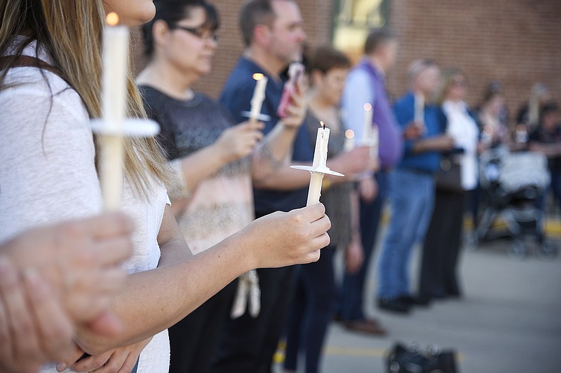 A crowd holds candles Monday during a candlelight vigil held in honor of Crime Victims' Rights Week at the Cole County Sheriff's Office. The Missouri Department of Corrections hosted the service.