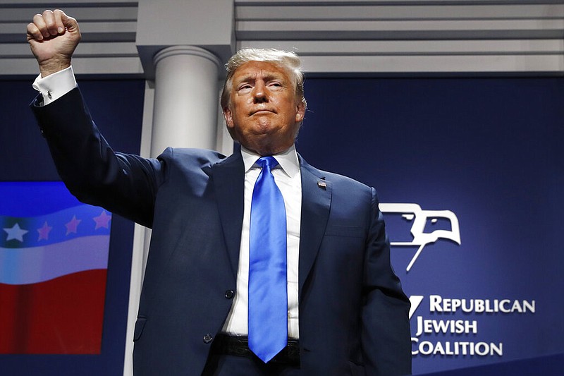 President Donald Trump holds up his fist as he finishes his speech at the Republican Jewish Coalition's annual leadership meeting, Saturday April 6, 2019, in Las Vegas.