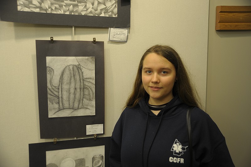 <p>Democrat photo/ Danisha Hogue</p><p>Russellville sixth-grader Cara Cinotto stands next to her cactus drawing at the Show-Me Conference Art Show.</p>