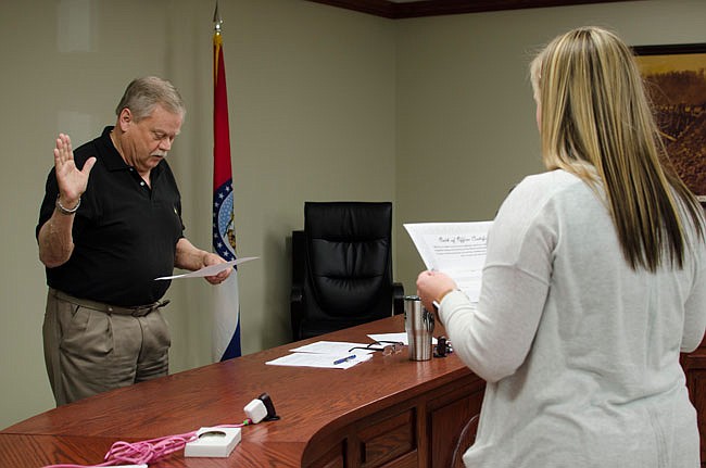 Holts Summit Ward 1 Alderman Mike Harvey, left, repeats the oath of office as Interim City Administrator Hanna Lechner reads it Tuesday during a special meeting. Harvey won a competitive election for the seat April 2.