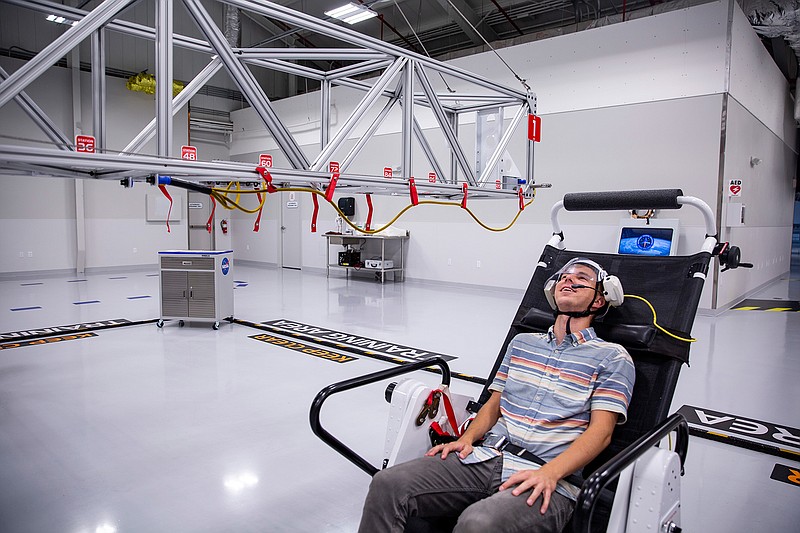 Reporter Patrick Connolly tries out the microgravity simulator in the Astronaut Training Experience at Kennedy Space Center on March 13, 2019. (Patrick Connolly/Orlando Sentinel/TNS)