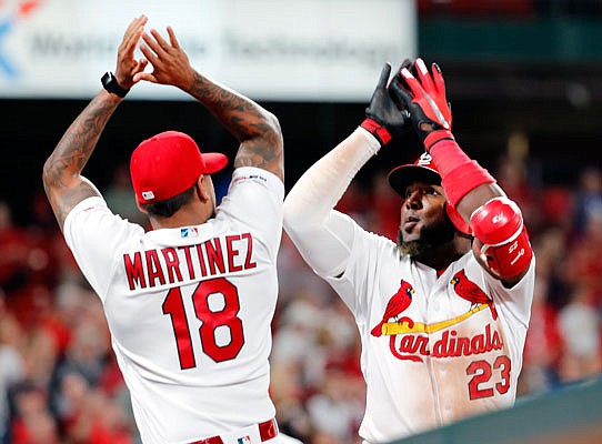 Marcell Ozuna climbs wall