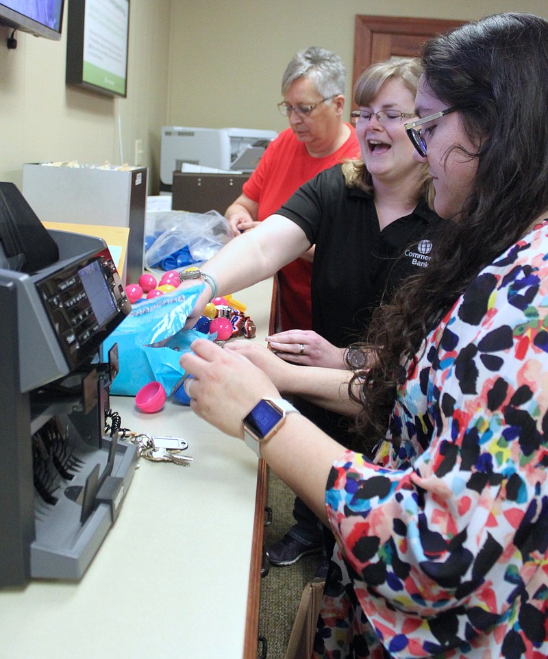 Pictured getting eggs ready behind the desk at Commerce Bank are employees, from left, Barb Vaughan, Lois Dunaway and Gaby Juarez.