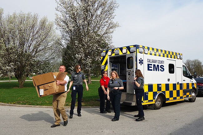 Callaway County EMS personnel, including (from left) Josh Loyd, Jacquelyn Harmon, assistant director Linda Ellis, Shannon Weber and Carrie Neville, unload Stop the Bleed packs. Fulton Public Schools became the third district to receive the first-aid packs.