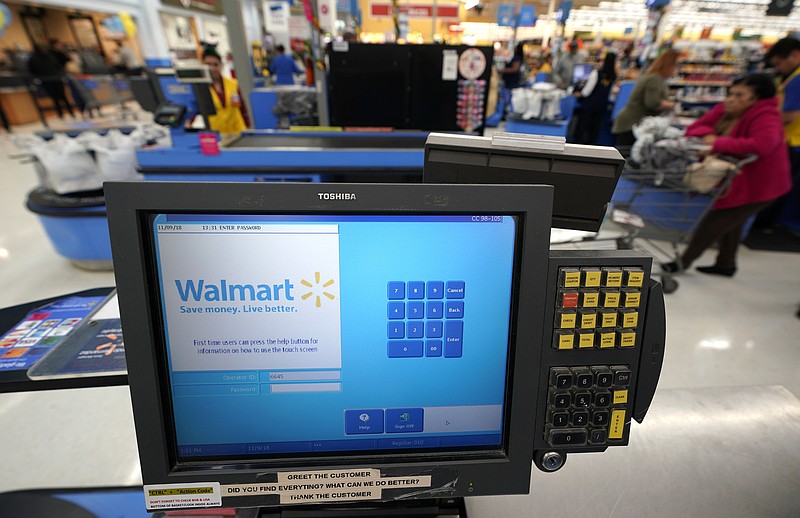 FILE- This Nov. 9, 2018, file photo shows a checkout scanner at a Walmart Supercenter in Houston. Walmart says it’s buying San Francisco-based ad tech startup Polymorph Labs as it looks to better compete with online rival juggernaut Amazon in targeting shoppers online. The world’s largest retailer has been quietly building its own advertising business with a unit called Walmart Media Group though that business is still smaller than Amazon’s. (AP Photo/David J. Phillip, File)