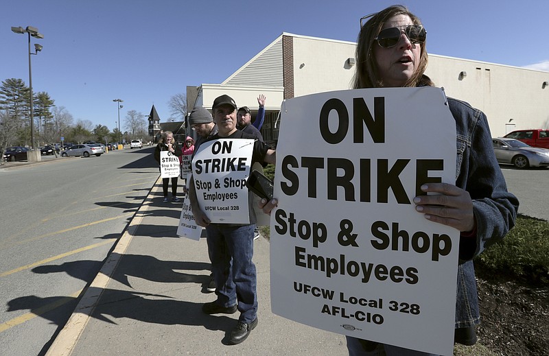 Union workers picket outside a Stop & Shop supermarket, Thursday, April 11, 2019, in Norwell, Mass., after workers walked off the job in Massachusetts, Rhode Island and Connecticut over stalled contract negotiations. (AP Photo/Charles Krupa)