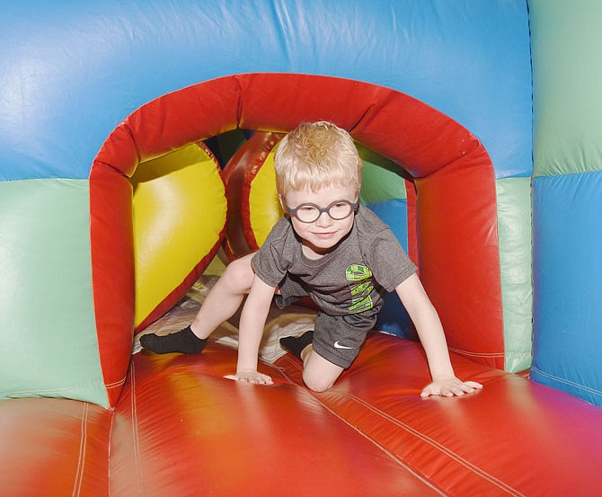 Remington Ward, 5, a student at Pumpkin Patch preschool reaches the exit of the bounce house in the gymnasium Thursday morning at Southwest Early Childhood Center. 