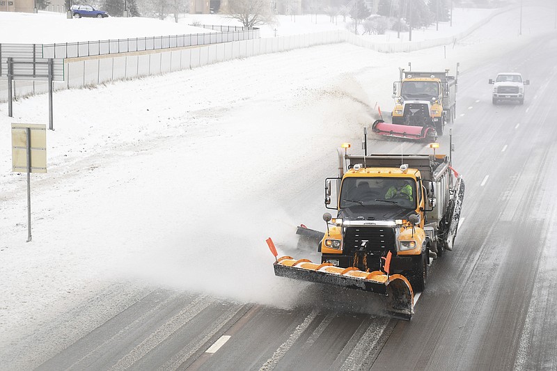 Snow plows clear Interstate 29 on Thursday, April 11, in Sioux Falls, S.D. Heavy snow and strong winds hammered parts of the central U.S. on Thursday, knocking out power to tens of thousands of people and creating hazardous travel conditions a day after pummeling Colorado. (Briana Sanchez/The Argus Leader via AP)