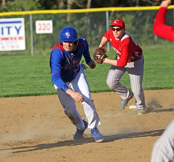 California's Tagen Higgins tries to avoid getting tagged during a rundown as Calvary Lutheran second baseman Jared Braun takes off after him during the third inning of Friday's game in the Calvary Lutheran/New Bloomfield Tournament at Calvary.