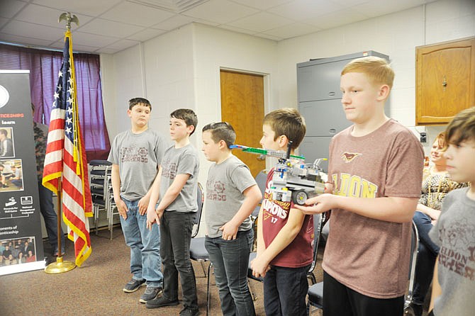 Members of the Gearheads robotics team present to the Eldon School Board in March. The board approved the mid-April trip to FIRST LEGO world championship.