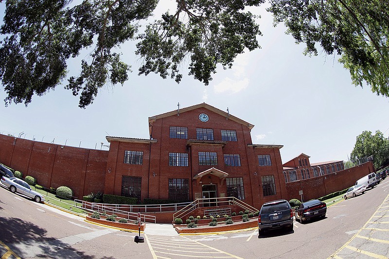 In this June 26, 2013, file photo, the Huntsville "Walls" Unit of the Texas Department of Criminal Justice Huntsville Unit, where the death chamber is located, is shown in Huntsville, Texas. Since 2011, the rate of attempted suicide in the prisons of Texas, one of America's most heavily incarcerated states, has steadily risen, records show. The rate of actual suicides has been more sporadic, although it was higher on average in the last five years than the five before that. (AP Photo/David J. Phillip, File)