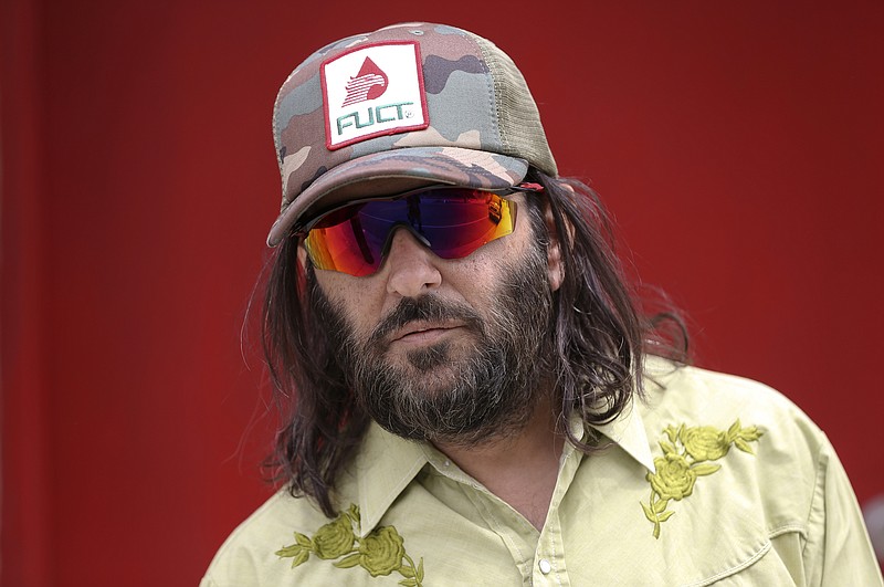 Los Angeles artist Erik Brunetti, the founder of the streetwear clothing company "FUCT," poses for a photo in Los Angeles Thursday, April, 11, 2019. “We wanted the viewer to question it: Like, is that pronounced the way I think it’s pronounced?” he said of his streetwear brand “FUCT,” which began selling clothing in 1991. On April 15, the Supreme Court will hear Brunetti’s challenge to a part of federal law that says officials should refuse to register trademarks that are “scandalous” or “immoral.” (AP Photo/Damian Dovarganes)