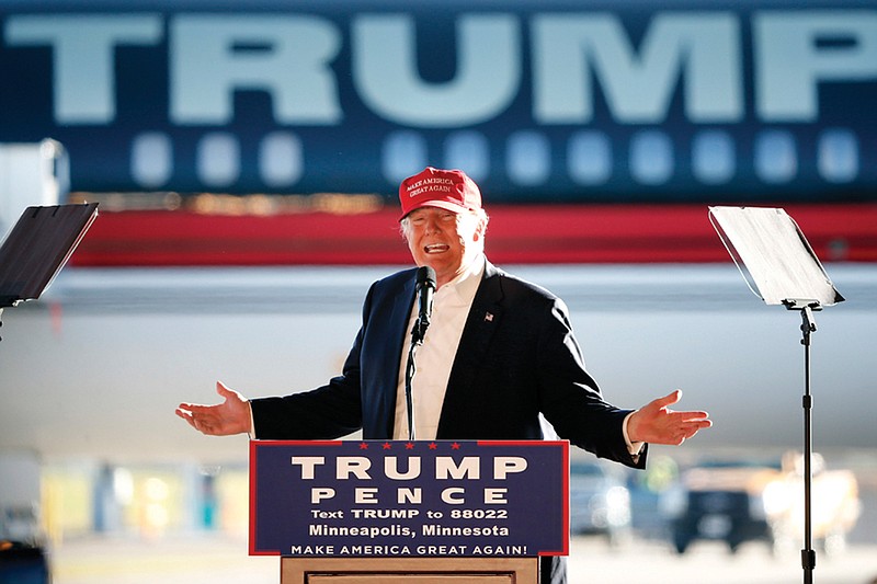 In this Sunday, Nov. 6, 2016 file photo, Republican presidential candidate Donald Trump addresses the crowd during a campaign stop at the Minneapolis International Airport. On Monday, April 15, 2019, President Trump is traveling to Minnesota, where he lost to Hillary Clinton by fewer than 45,000 votes in 2016, but his re-election campaign is also targeting New Mexico, Nevada, and New Hampshire -all states where he trailed by under 100,000 votes.  (AP Photo/Charles Rex Arbogast)