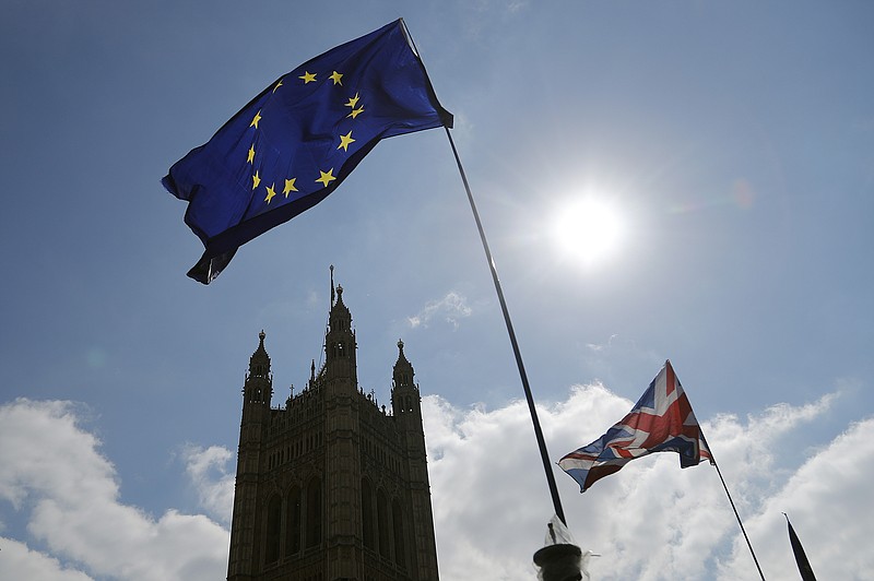 Protestor flags fly opposite the Houses of Parliament in London, Thursday, April 11, 2019. European Union leaders on Thursday offered Britain an extension to Brexit that would allow the country to delay its EU departure date until Oct. 31. (AP Photo/Frank Augstein)
