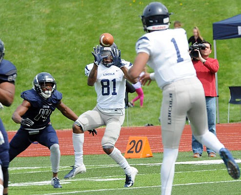 Lincoln quarterback Chancellor Johnson (1) throws the ball to Khristian Johnson (81) during Saturday afternoon's Spring Game at Dwight T. Reed Stadium.