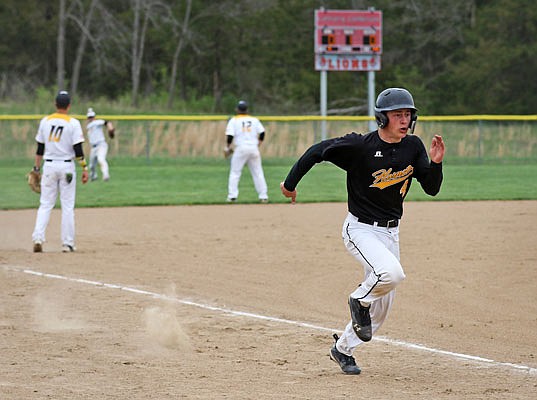 St. Elizabeth's Coltin Green sprints toward home plate to score a run as Vienna left fielder Spencer Wieberg throws the ball back to the infield during the first inning of Saturday's championship game of the Calvary Lutheran/New Bloomfield Tournament at Calvary.