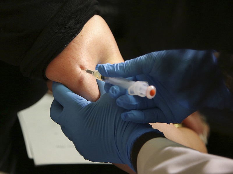 In this March 27, 2019, file photo, a woman receives a measles, mumps and rubella vaccine at the Rockland County Health Department in Pomona, N.Y. The Centers for Disease Control and Prevention reports that U.S. measles cases have surged this year, and at this pace will set a record for most illnesses in 25 years. Nearly two-thirds of the cases reported have been in New York, and most of those have been unvaccinated people in Orthodox Jewish communities.
