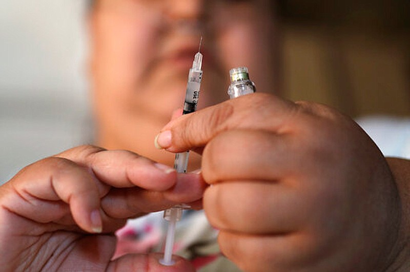 A woman with Type 2 diabetes prepares to inject herself with insulin on April 18, 2017,  at her home in Las Vegas. The skyrocketing price of insulin has some diabetics scrambling to cover the cost of the life-saving medication. Others are skipping doses or using smaller amounts than needed, and sometimes landing in the ER, patients and advocates recently told Congress.  
