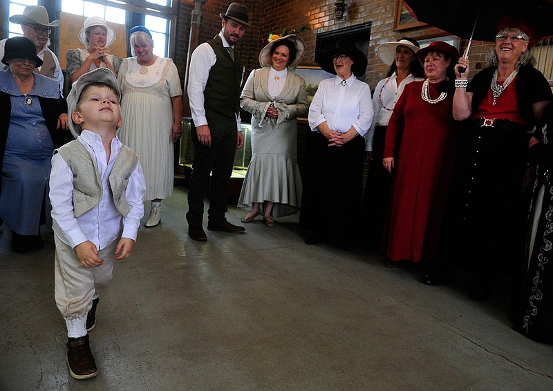 In this April 6, 2019, photo, Jonah Charman, 3, impatiently drags his feet as he and others await the decision of judges in a period costume contest in the Roaring Ranger Oil Boom Museum in Ranger, Texas. Jonah came with his parents Joe and Savannah from San Antonio to celebrate the centennial of Ranger's incorporation. The Charman family were named as one of the winners of the contest.