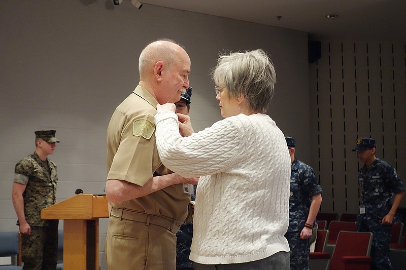 Leslie Denning pins a new insignia on her husband, former commanding officer of the Thomas Jefferson Division of the Sea Cadets James Denning, as he's promoted from lieutenant to lieutenant commander during a Sunday ceremony at the Missouri National Guard's Ike Skelton Training Facility. The ceremony was in celebration of Thomas Jefferson Division of the Sea Cadets' 30th anniversary.