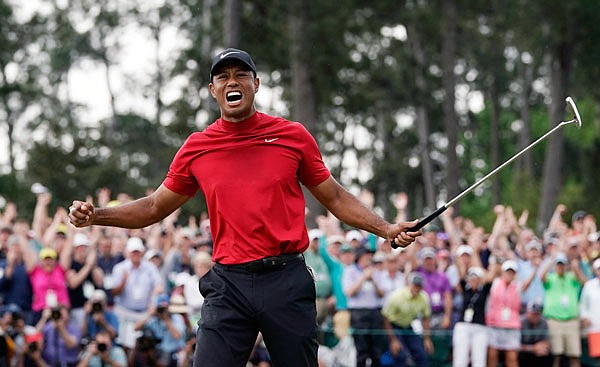 Tiger Woods lets out a yell after sinking the final putt Sunday to win the Masters at the Augusta National Golf Club in Augusta, Ga.