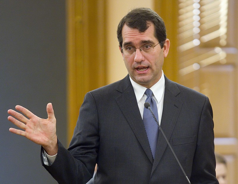 FILE - In this Jan. 23, 2015, file photo, Kansas Attorney General Derek Schmidt talks to lawmakers at the Statehouse in Topeka, Kan. Schmidt's office filed legal arguments Monday, April 15, 2019 defending a new public school funding law. It increases education funding by roughly $90 million a year. (Thad Allton/The Topeka Capital-Journal via AP, File)