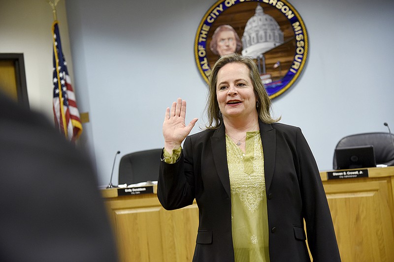 Jefferson City Prosecutor Gaylin Carver is sworn in to office Monday by Cole County Presiding Judge Patricia Joyce at the Municipal Building.