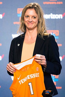 Kellie Harper holds a Tennessee jersey last week during a press conference announcing her as the new head coach of the Lady Vols in Knoxville, Tenn.