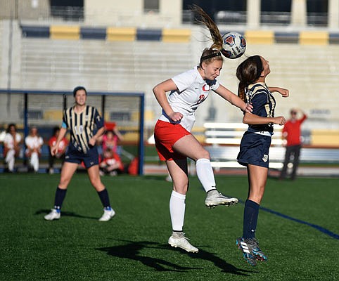 Bailey Henson of Helias (far right) and Maddie Helling of Union compete for a header during Monday night's game at the Crusader Athletic Complex.