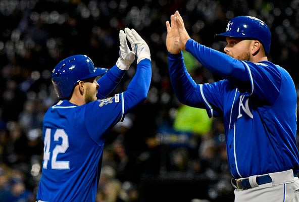 Chris Owings (left) high-fives Royals teammate Lucas Duda after they scored on Owings' two-run home run during the second inning of Monday night's game against the White Sox in Chicago.