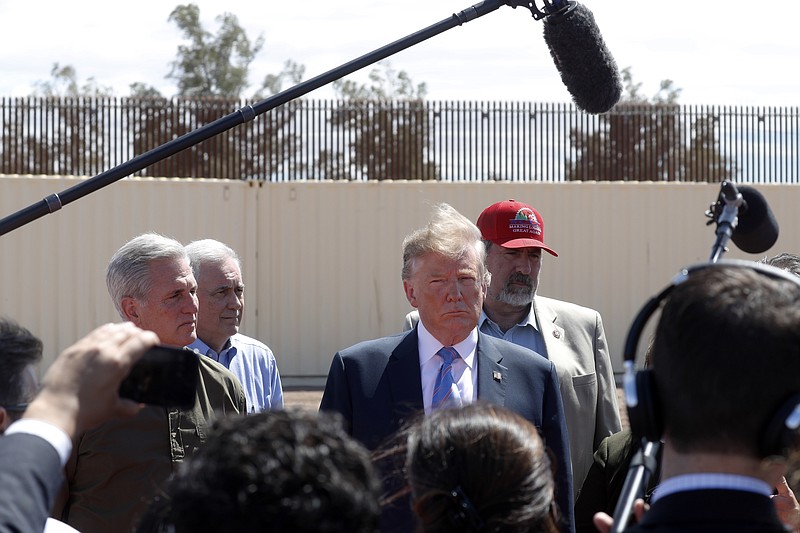 FILE - In this April 5, 2019, file photo, President Donald Trump visits a new section of the border wall with Mexico in Calexico, Calif. When Trump insisted last year that the border was in crisis, his warnings landed with a thud. Now, as the situation at the border has deteriorated to a level of alarm, Trump is again being met with skepticism, even as members on both sides of the aisle agree that there is a legitimate humanitarian emergency, with federal authorities and non-profits unable to cope with the influx of tens of thousands of Central American families seeking refuge in the U.S. (AP Photo/Jacquelyn Martin, File)