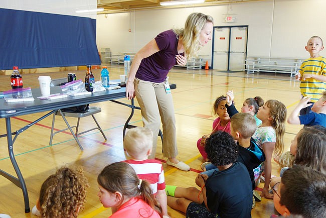 Dietician Lucy Crain tells Bush Elementary first-graders about how to make healthy eating choices and avoid eating excess sugar. The children were surprised to learn sugar can come in cubes.