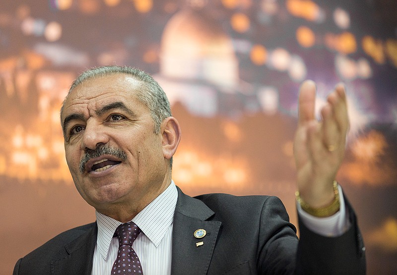 Palestinian Prime Minister Mohammad Shtayyeh italks during an interview with The Associated Press, at his office in the West Bank city of Ramallah, Tuesday, April 16, 2019. Stayyeh accused the United States of declaring "financial war" on his people and said an American peace plan purported to be in the works will be "born dead." (AP Photo/Nasser Nasser)