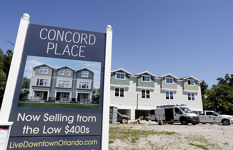 In this Tuesday, April 16, 2019, photo, new town homes under construction are being built in vacant lots in a neighborhood near downtown Orlando, Fla. The U.S. Census Bureau said Thursday, April 18 that Orlando grew by 60,000 people from mid-2017 to mid-2018, making it the fifth biggest metro increase in pure numbers in the nation. (AP Photo/John Raoux)