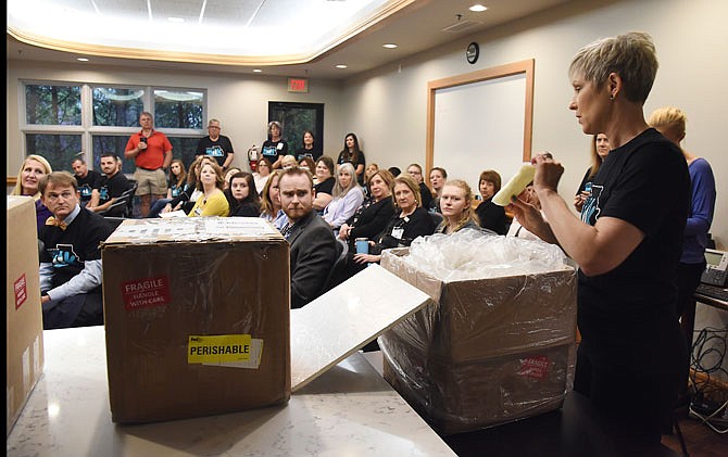 Melinda Ridenhour, Milk Depot coordinator, shows what the bags of human donor milk look like Thursday before packaging it up to ship to St. Luke's Hospital in Kansas City, where it will be stored until needed. 