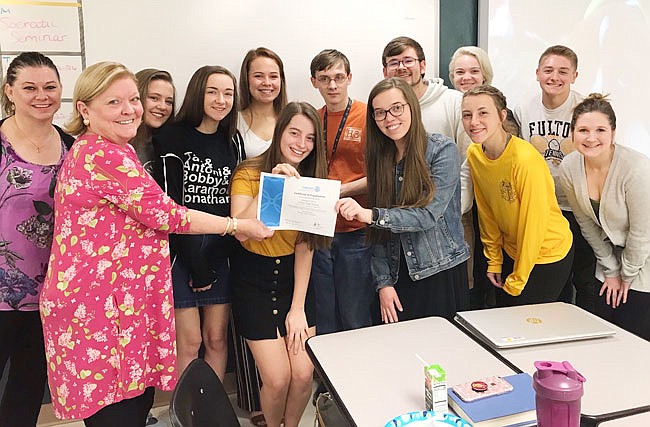 Members of the Interact Club at Fulton High School have received their official recognition from Rotary International. Debbie Laughlin, one of the sponsors and president of the Fulton Rotary Club, presented the certificate to Anna Bonderer.