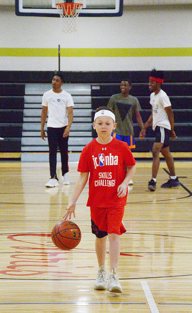 Maxon Fischer shoots hoops Wednesday at The Linc.