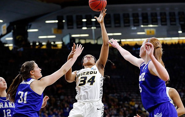 Missouri forward Emmanuelle Tahane drives to the basket between Drake teammates Monica Burich (left) and Becca Hittner during last month's NCAA Tournament first-round game in Iowa City, Iowa.