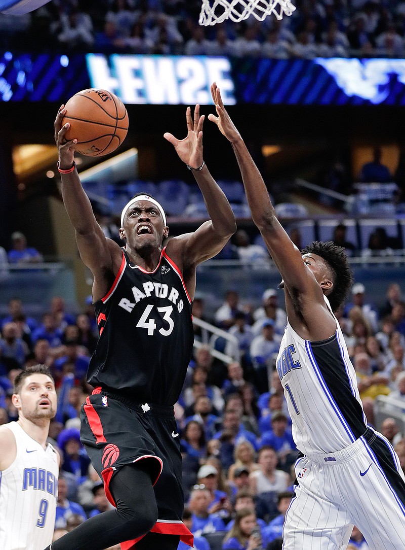Toronto Raptors' Pascal Siakam (43) shoots against Orlando Magic's Nikola Vucevic (9) and Jonathan Isaac, right, during the first half in Game 3 of a first-round NBA basketball playoff series, Friday, April 19, 2019, in Orlando, Fla. (AP Photo/John Raoux)