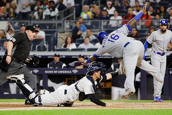 Yankees catcher Kyle Higashioka tags out Martin Maldonado of the Royals at home plate as umpire James Williams watches during the third inning of Friday night's game in New York.