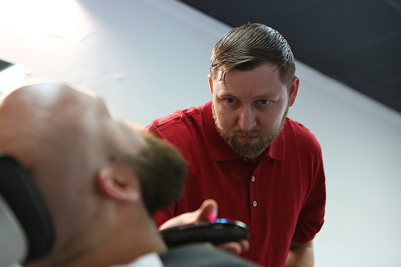 Stephen Brown, owner of Hairy Armadillo Barbering, trims Jared Rhodes' beard at Hairy Armadillo Barbering on Friday in Texarkana, Ark. The barbershop has been open for about two weeks now and is located 504 Wood St. 