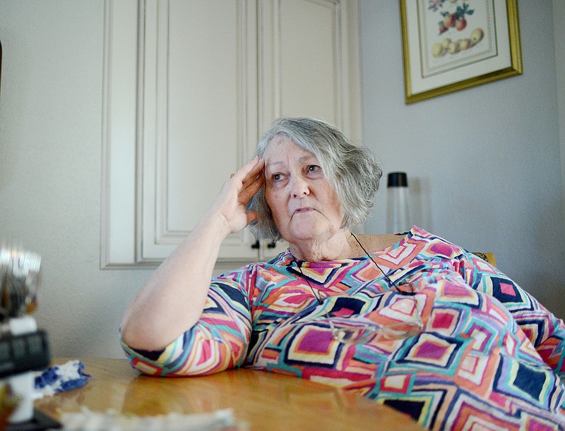 Paula Hinshaw sits at her dining room table Friday as she voices her concerns about people not getting immunizations after having suffered from the measles herself.