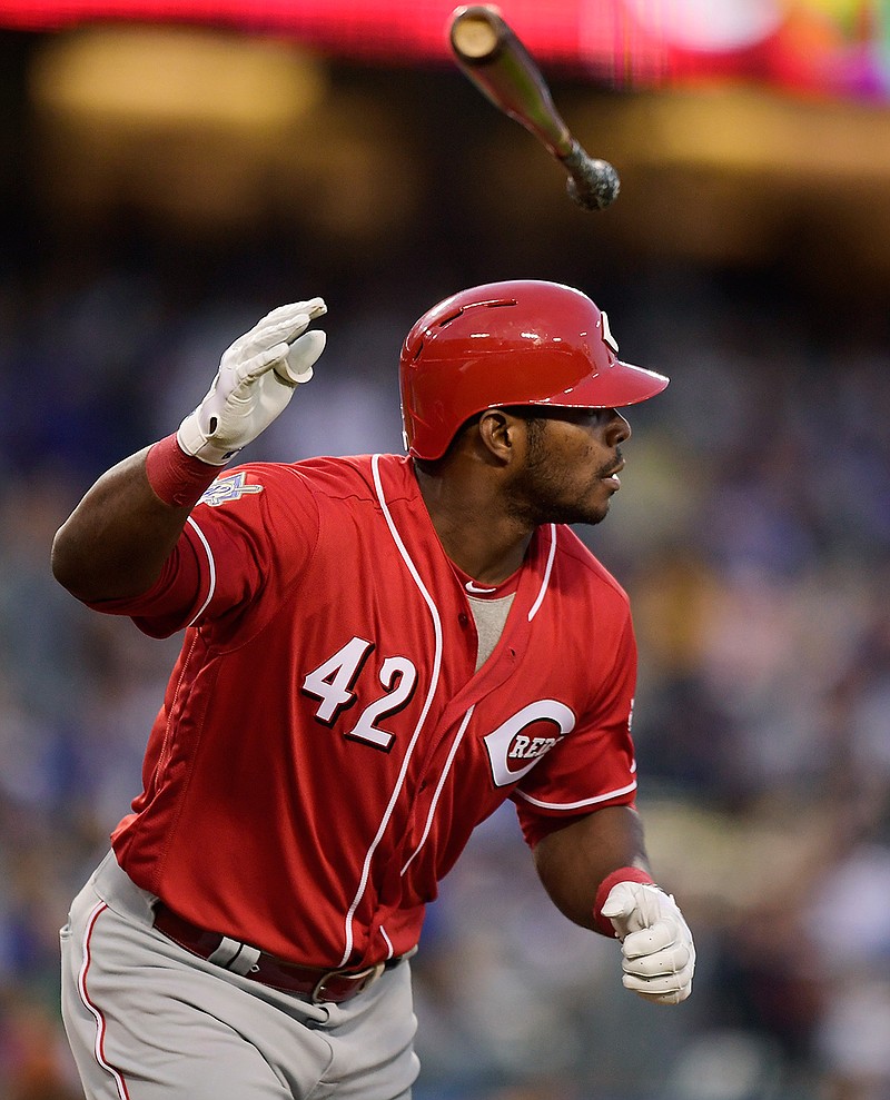 Cincinnati Reds' Yasiel Puig flips his bat after hitting a solo home run during the first inning of a baseball game against the Los Angeles Dodgers, Monday, April 15, 2019, in Los Angeles. (AP Photo/Mark J. Terrill)