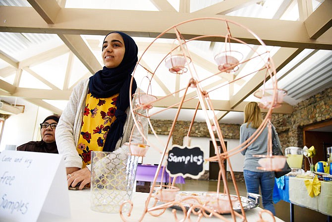 Ninth-grader Sant Gaballah stands at her business' table next to her samples of Baklava on Saturday at the Children's Business Fair at McClung Park. Gaballah's business, Baklava and Beyond featured homemade baklava, tassels and bracelets.